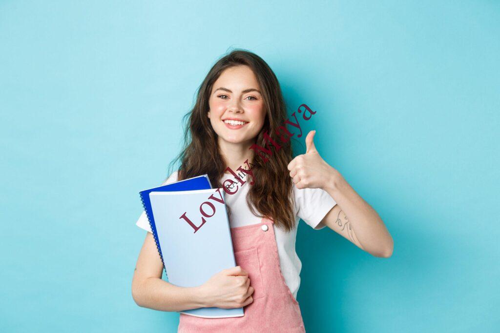 young-woman-attend-courses-girl-student-studying-holding-notebooks-showing-thumb-up-approval-recommending-company-standing-blue-background-scaled-2.jpg